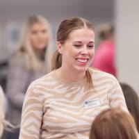 Smiling woman talking to a friend